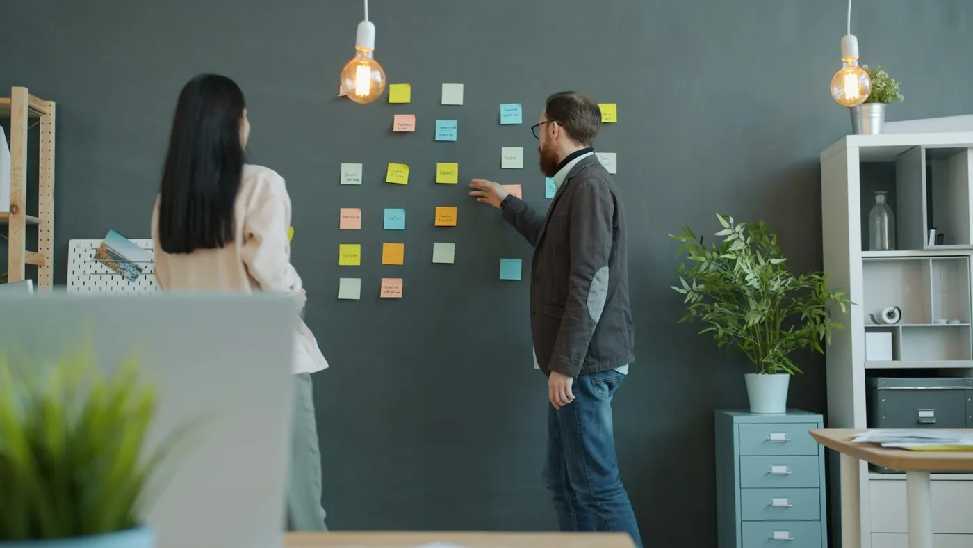 Team planning a product on a wall of sticky notes